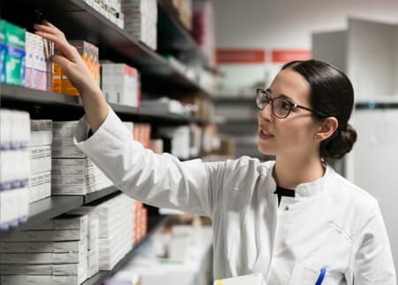 Pharmaceutical technician looking through inventory